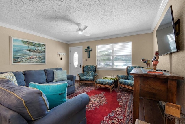 living room featuring hardwood / wood-style floors, ceiling fan, crown molding, and a textured ceiling