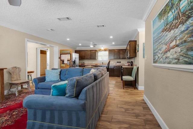 living room with crown molding and a textured ceiling