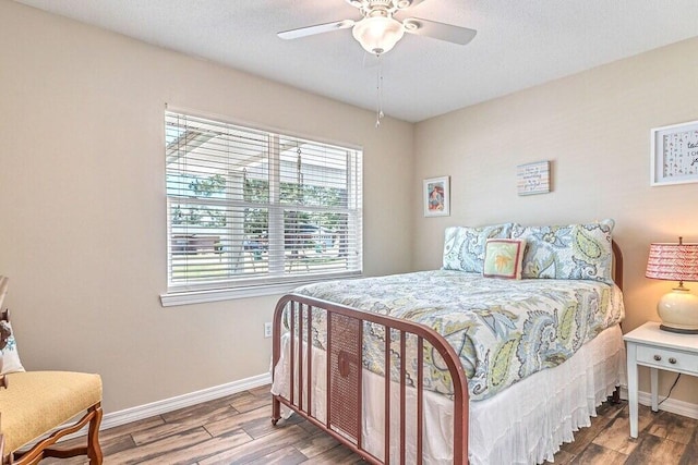 bedroom with wood-type flooring and ceiling fan