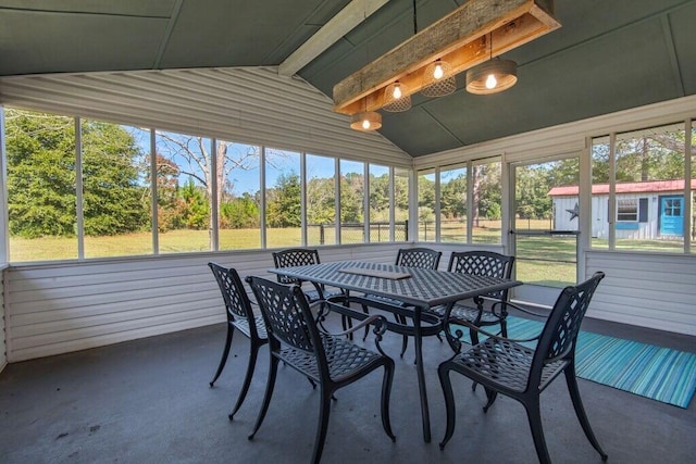 sunroom featuring vaulted ceiling