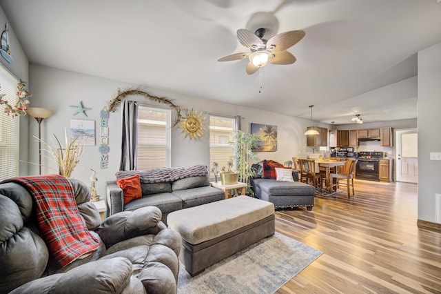 living room with light hardwood / wood-style flooring and ceiling fan