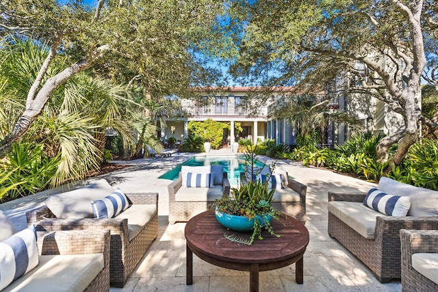 pool featuring a patio area and an outdoor living space