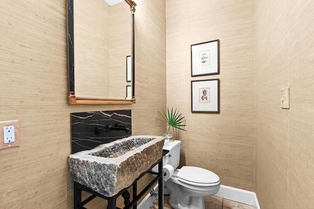 half bathroom featuring toilet and tile patterned floors