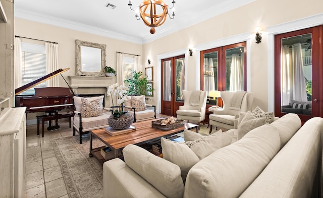 living area featuring visible vents, stone tile flooring, crown molding, a fireplace, and a chandelier