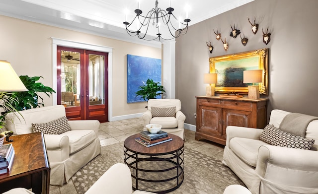 living area with light tile patterned floors, baseboards, crown molding, french doors, and a notable chandelier