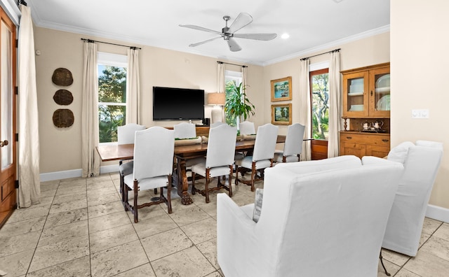 dining room with baseboards, ceiling fan, and crown molding