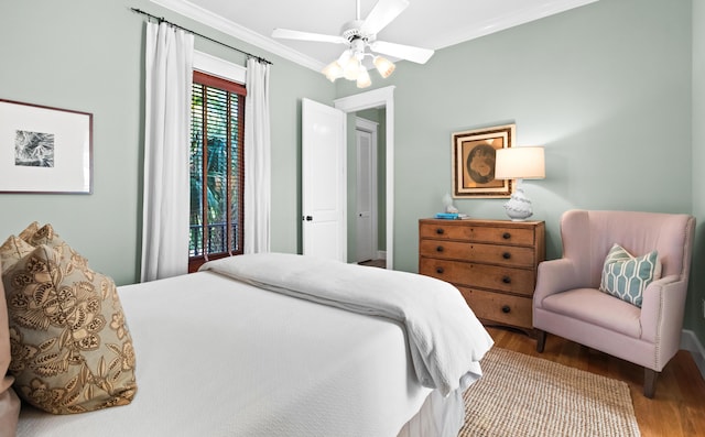 bedroom featuring a ceiling fan, ornamental molding, and wood finished floors