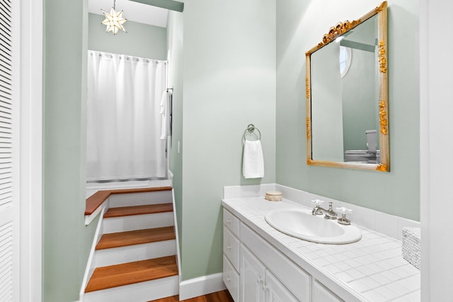 bathroom featuring baseboards and vanity