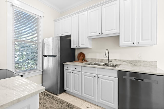 kitchen featuring a sink, white cabinets, ornamental molding, appliances with stainless steel finishes, and light stone countertops