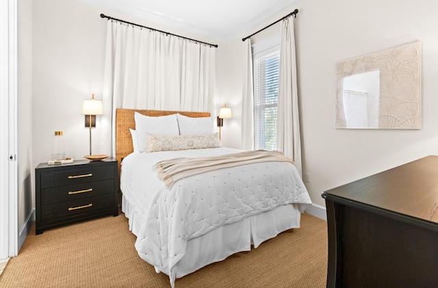 bedroom with light colored carpet and baseboards