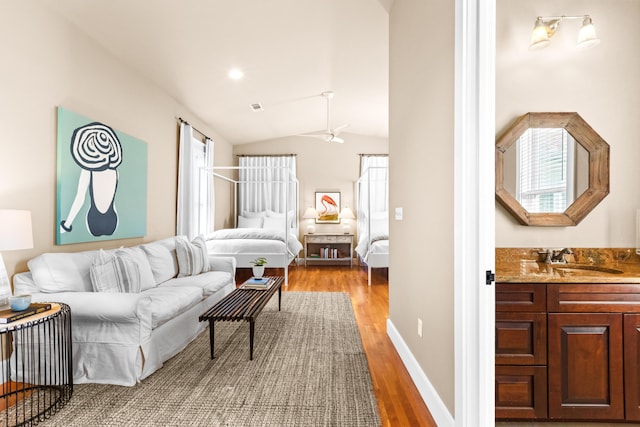 living area featuring lofted ceiling, recessed lighting, visible vents, light wood-type flooring, and baseboards