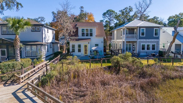 back of house featuring a balcony