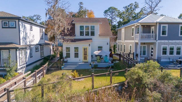 rear view of property with a balcony