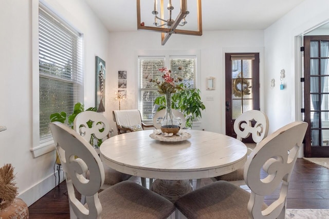 dining room featuring dark hardwood / wood-style flooring, a chandelier, and plenty of natural light