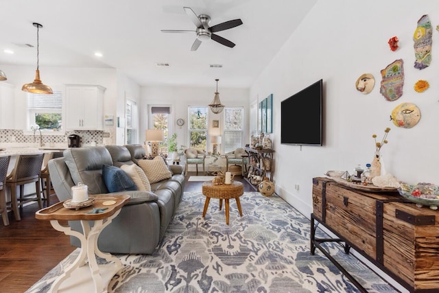 living room featuring hardwood / wood-style flooring, ceiling fan, and a wealth of natural light