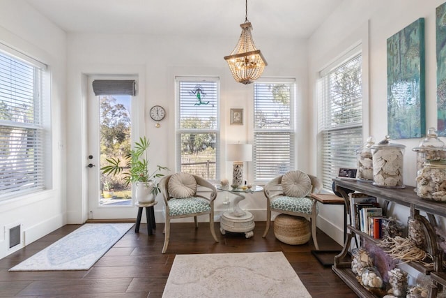 sunroom featuring a chandelier