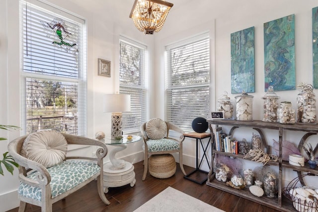 living area featuring a notable chandelier and dark hardwood / wood-style floors