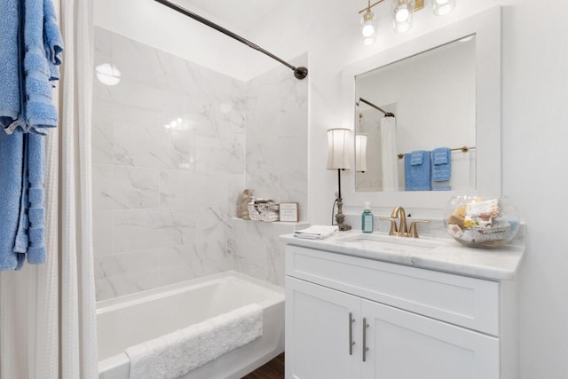 bathroom featuring shower / tub combo and vanity