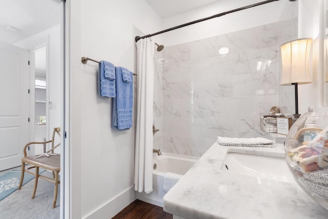 bathroom featuring vanity, hardwood / wood-style floors, and shower / bath combination with curtain