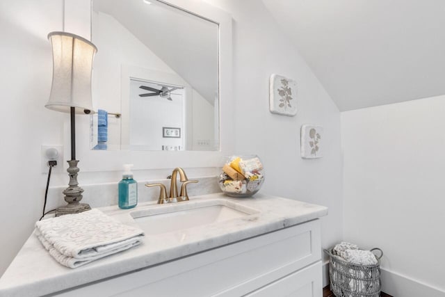 bathroom featuring ceiling fan, vaulted ceiling, and vanity