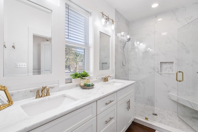 bathroom with vanity and a shower with shower door