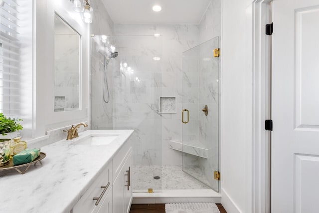 bathroom with vanity and a shower with shower door