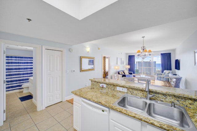 kitchen with white cabinetry, sink, a notable chandelier, white dishwasher, and light tile patterned floors