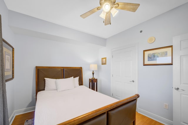 bedroom with ceiling fan and light hardwood / wood-style flooring