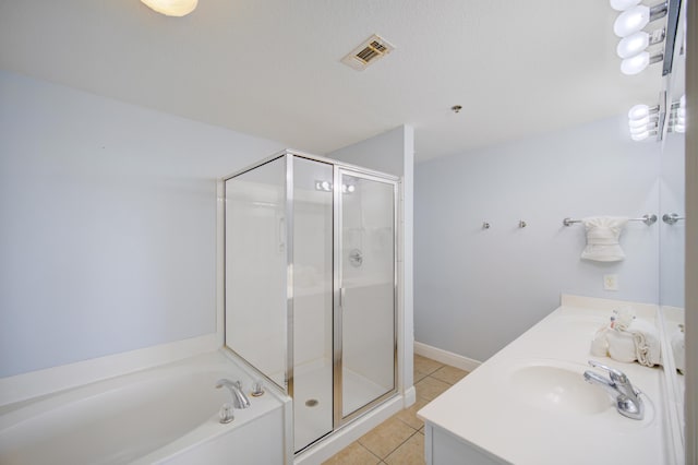 bathroom with tile patterned floors, vanity, and shower with separate bathtub