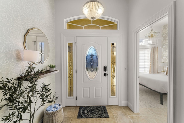 entrance foyer with light tile patterned floors and an inviting chandelier