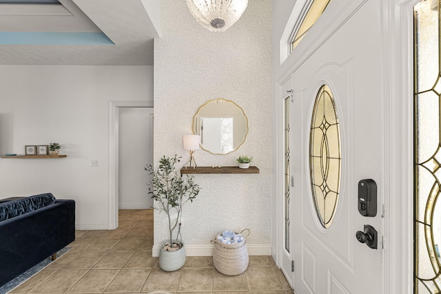 tiled entryway featuring a raised ceiling