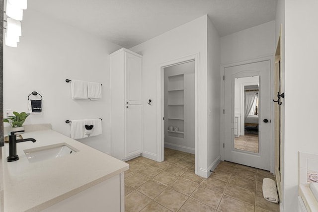 bathroom featuring tile patterned flooring and vanity