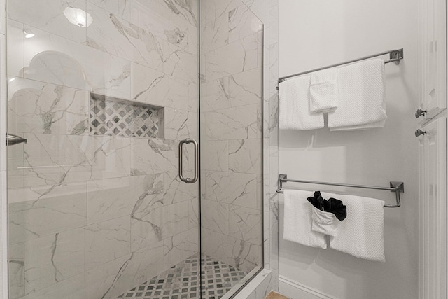 bathroom featuring a shower with shower door