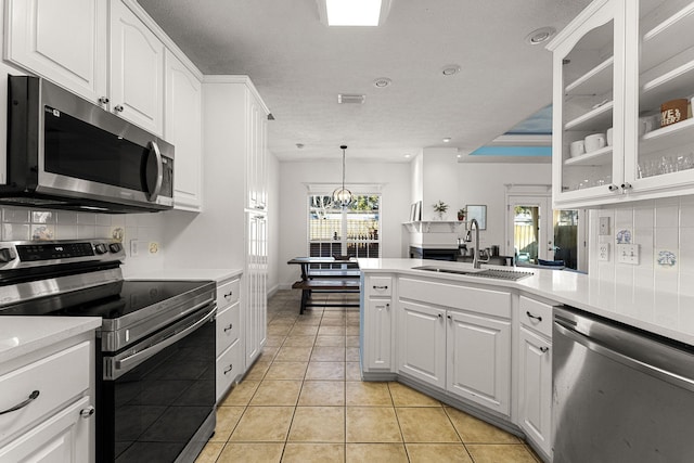 kitchen featuring white cabinets, light tile patterned floors, stainless steel appliances, and sink