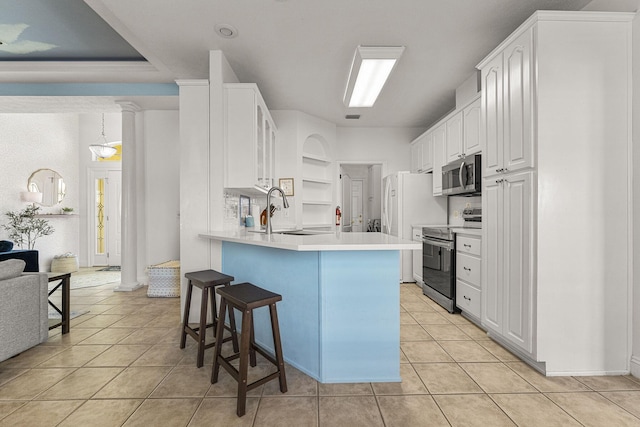 kitchen featuring white cabinetry, sink, stainless steel appliances, kitchen peninsula, and light tile patterned flooring