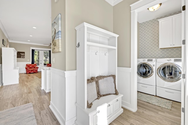 washroom featuring french doors, cabinets, washing machine and dryer, light hardwood / wood-style flooring, and crown molding