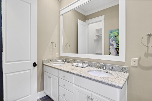 bathroom with vanity and ornamental molding