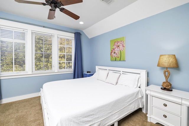 bedroom with multiple windows, ceiling fan, light colored carpet, and vaulted ceiling