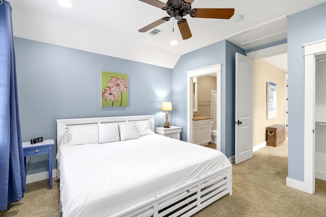 carpeted bedroom with connected bathroom, ceiling fan, and lofted ceiling