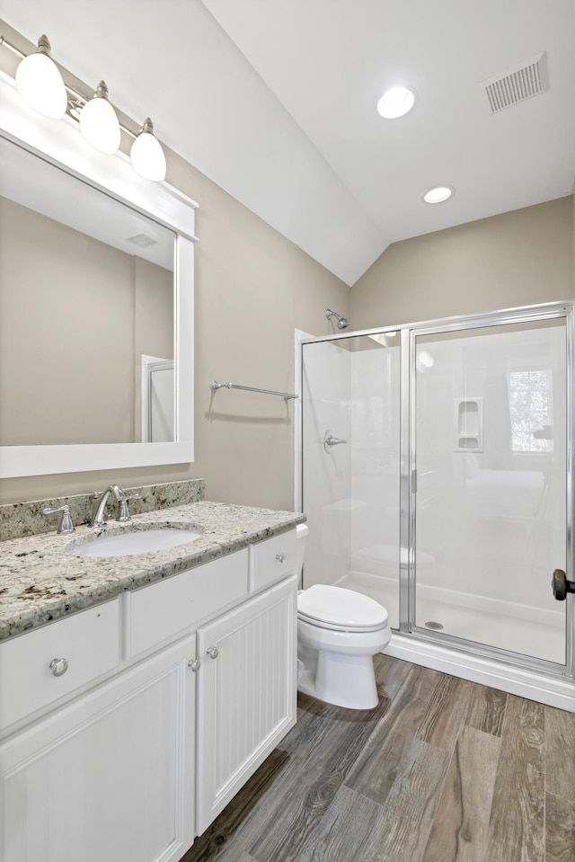 bathroom with vanity, toilet, walk in shower, and vaulted ceiling