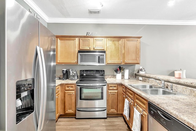 kitchen with crown molding, sink, light hardwood / wood-style flooring, and appliances with stainless steel finishes