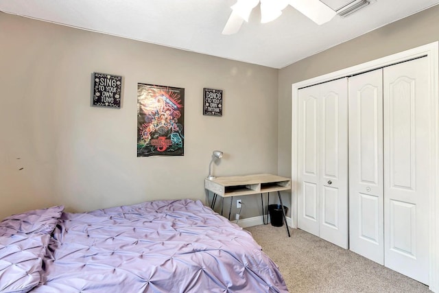 carpeted bedroom featuring a closet and ceiling fan