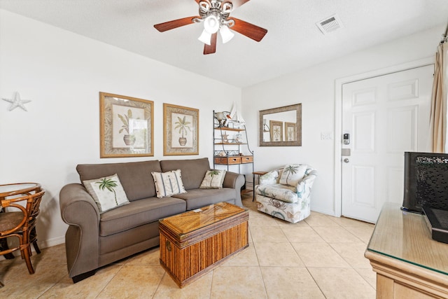 tiled living room featuring ceiling fan