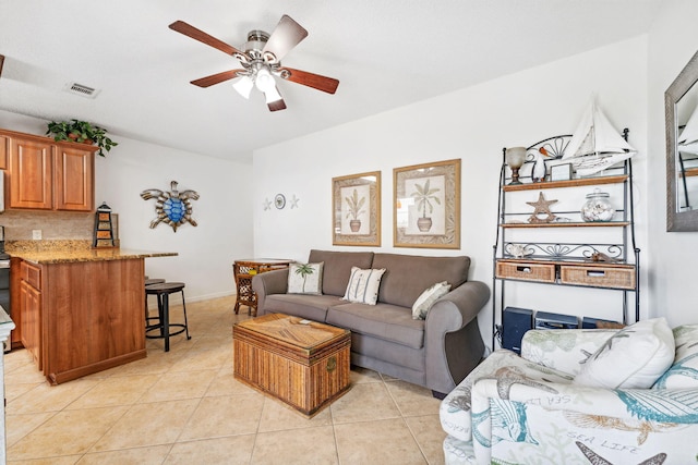 tiled living room with ceiling fan