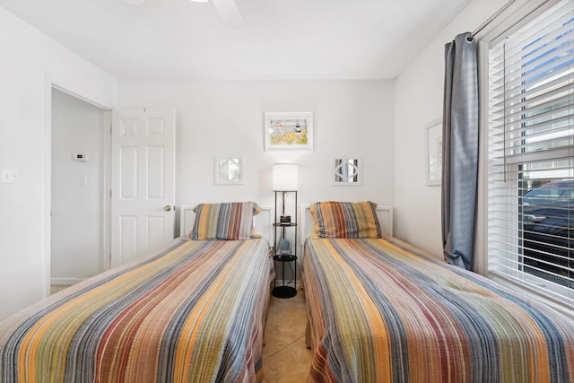 tiled bedroom with ceiling fan