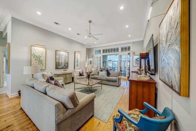 living room featuring ceiling fan, light hardwood / wood-style floors, and crown molding