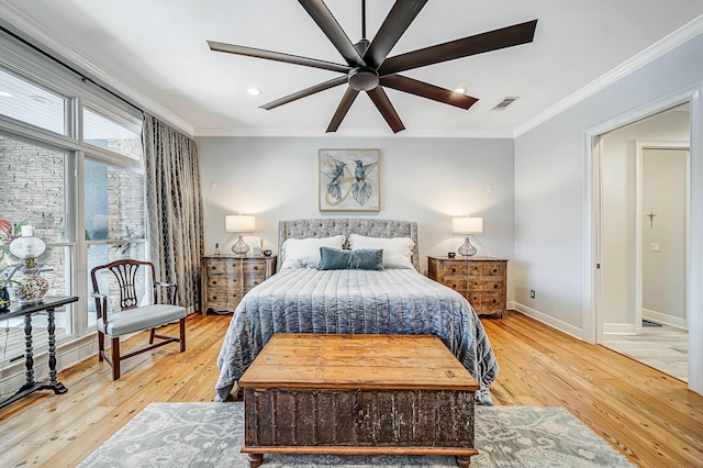 bedroom featuring ceiling fan, crown molding, and light hardwood / wood-style flooring