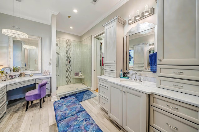 bathroom with vanity, crown molding, and walk in shower