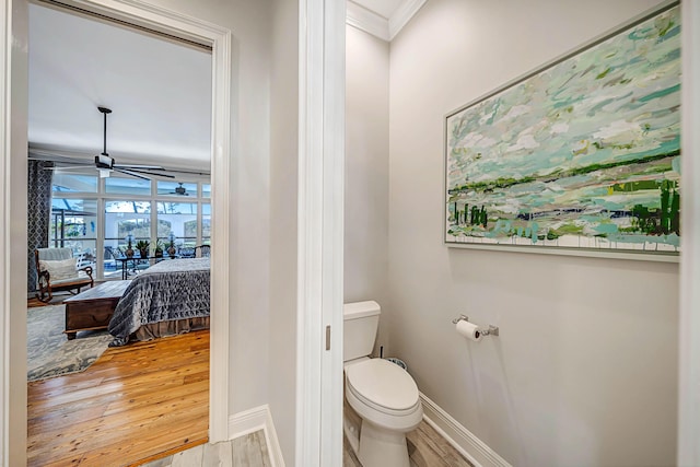 bathroom featuring crown molding, toilet, ceiling fan, and hardwood / wood-style flooring