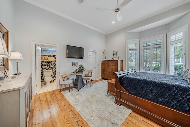 bedroom with ensuite bath, ceiling fan, crown molding, and light wood-type flooring